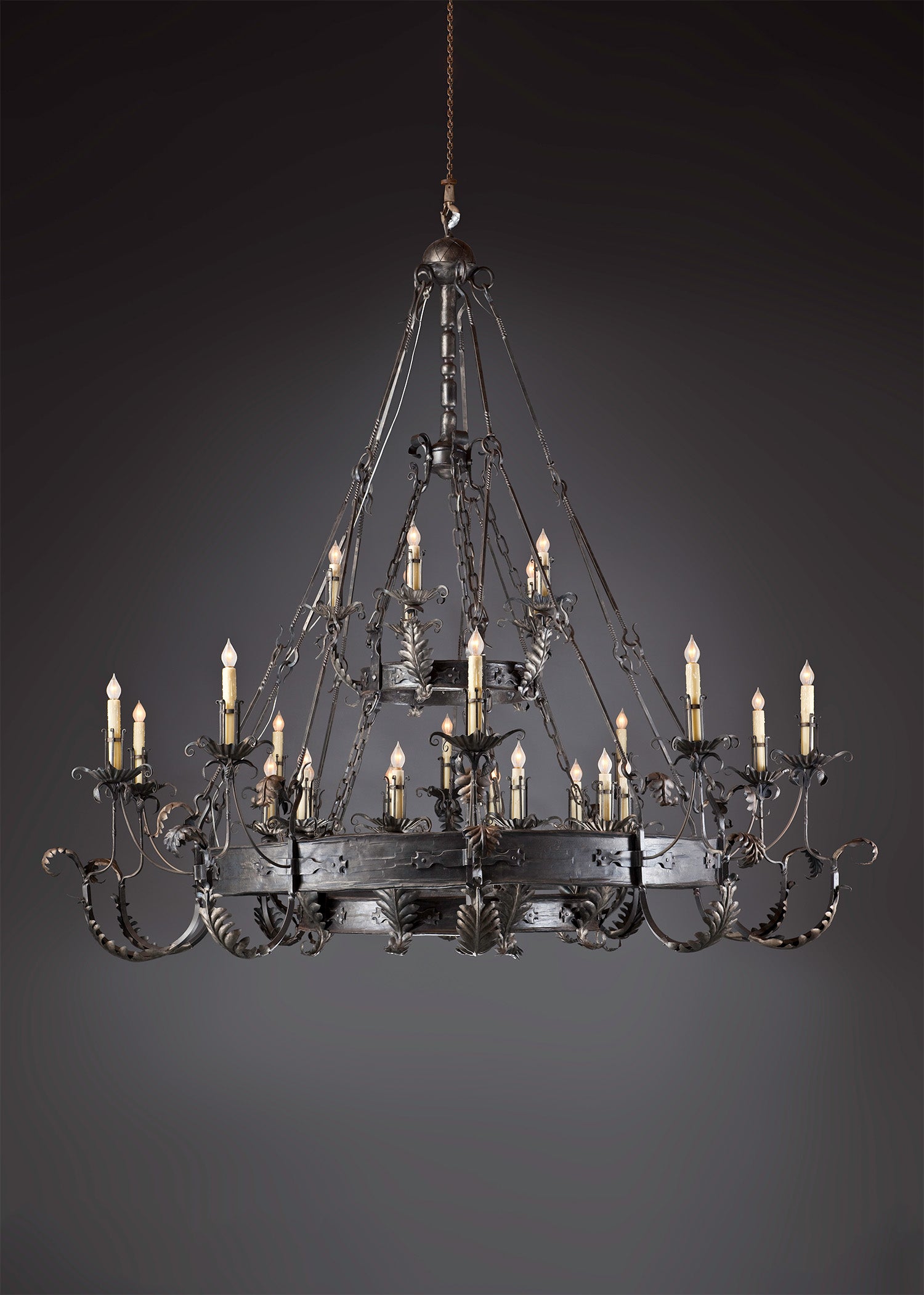 Renaissance style custom wrought iron chandelier with delicate leaf details and candle light bulbs.
