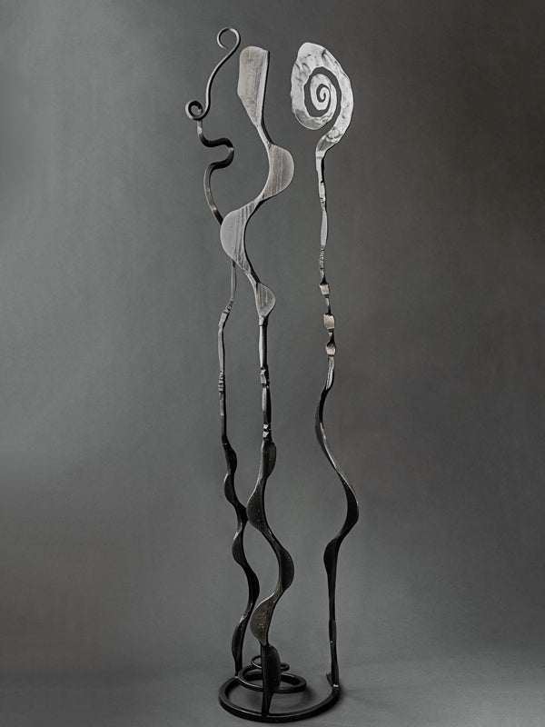 High end metal sculpture with a metallic black finish made by blacksmith Christopher Thomson's Blooms sculpture series.