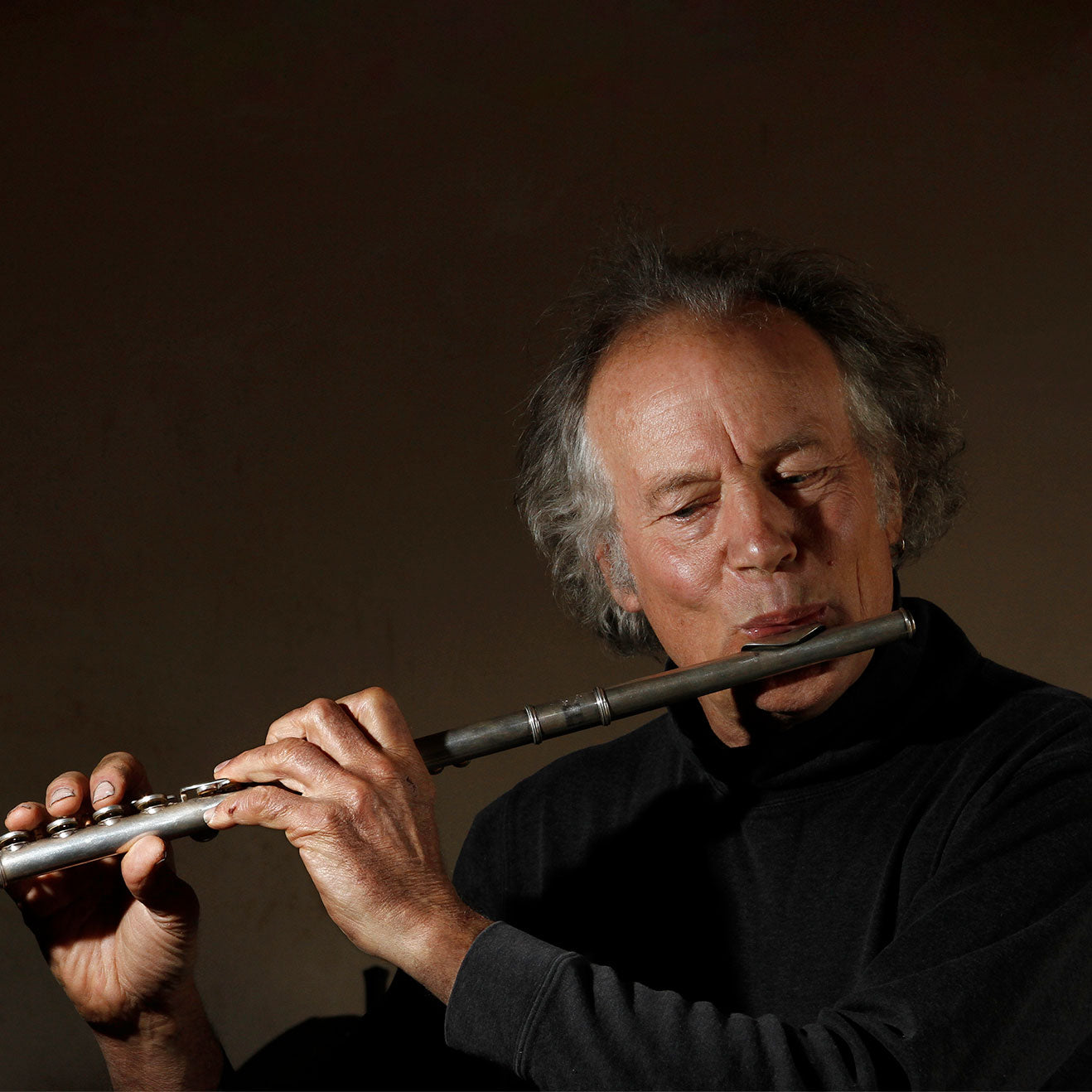 Blacksmith, Christopher Thomson, playing the flute.
