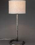 Wrought iron lamp with a circle base and a contemporary linen drum shade.