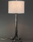 Wrought iron lamp with a metal sheave wrapped around the base. Shown with a linen drum shade. Lamp made by blacksmith, Christopher Thomson Ironworks.