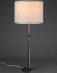 Wrought Iron Etruscan Lamp with a woven linen drum shade.