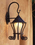 Hand forged wrought iron hanging wall lantern with glass panels, crafted in a Southwestern style, perfect for outdoor or entryway lighting.