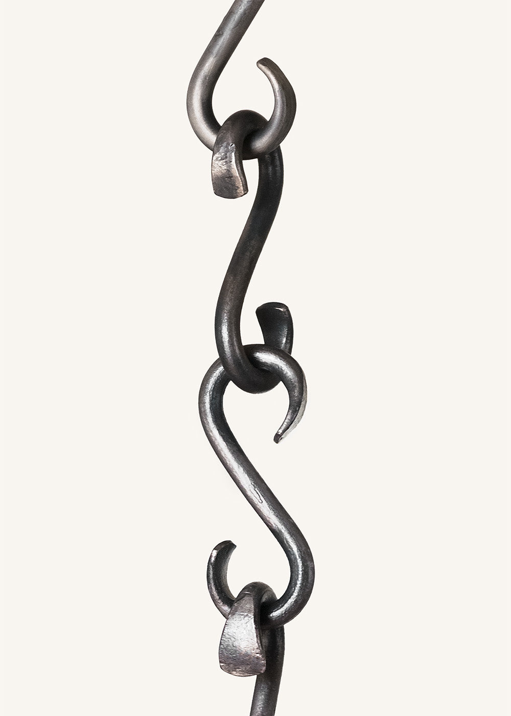 Individual hand forged wrought Iron s-hooks linked together to make a chain. Made by blacksmith, Christopher Thomson.