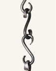 Individual hand forged wrought Iron s-hooks linked together to make a chain. Made by blacksmith, Christopher Thomson.
