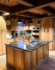 Custom hanging wrought iron pendant lights over a kitchen island.