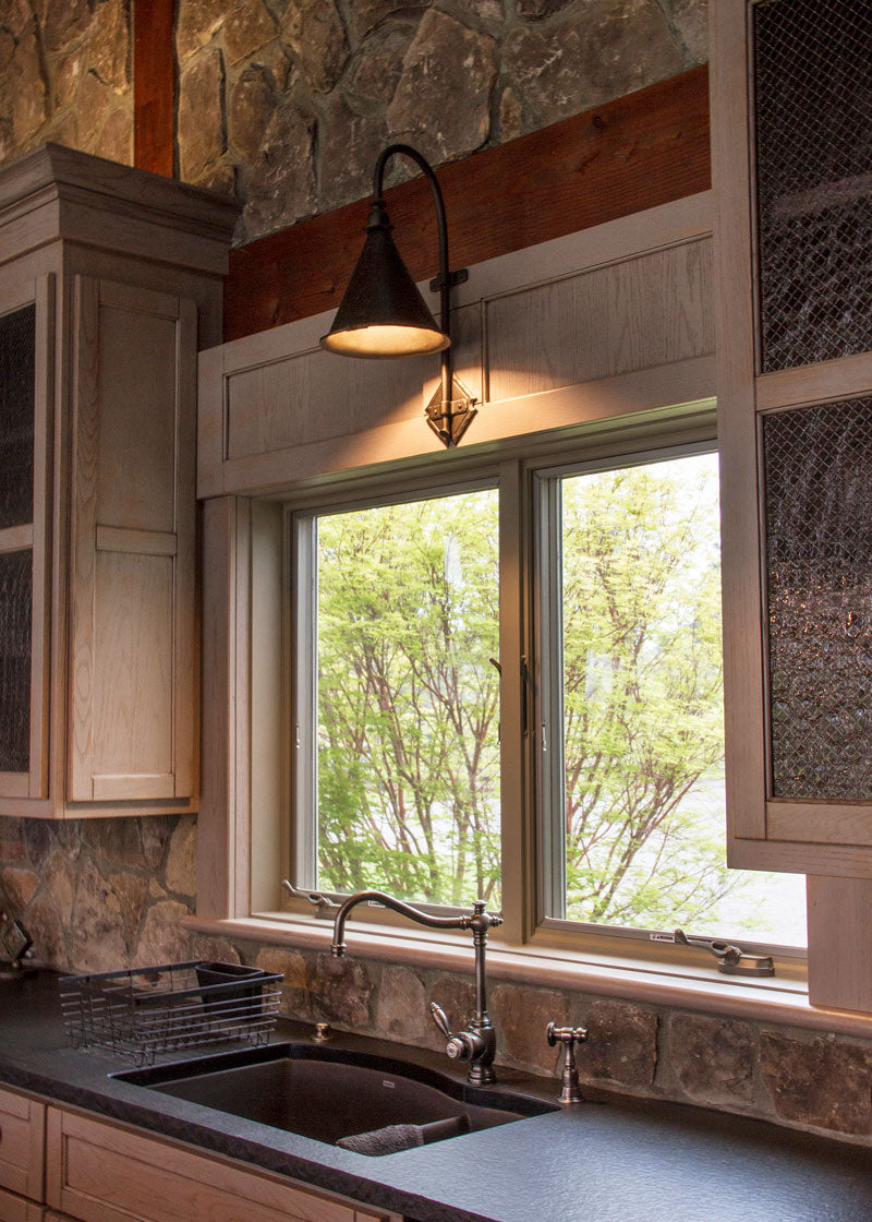 Large Entry Iron Sconce above a kitchen sink.