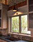 Large Entry Iron Sconce above a kitchen sink.