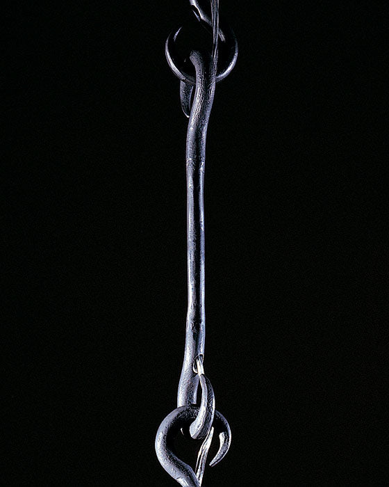 Long hook chain link made out of hand forged steel.