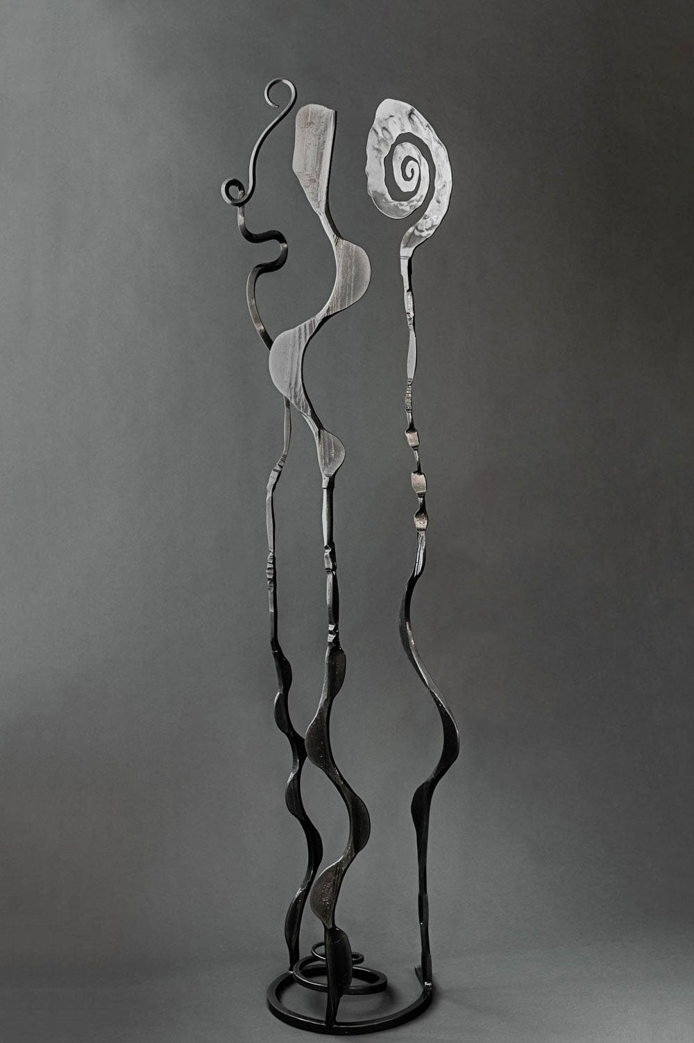 Metallic black hand forged abstract garden sculpture that can also be place indoors.