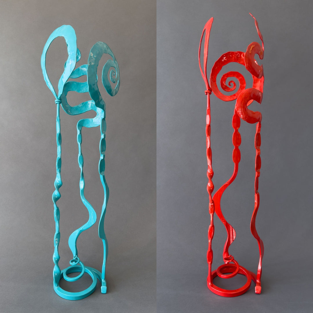 A Turquoise and Red Baby Bloom steel sculpture side by side.