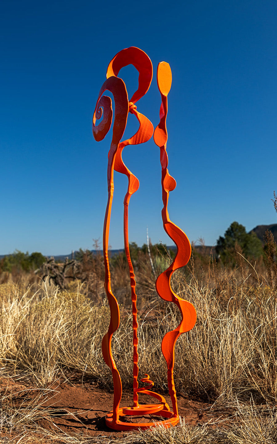 Orange colored steel abstract Baby Bloom sculpture.