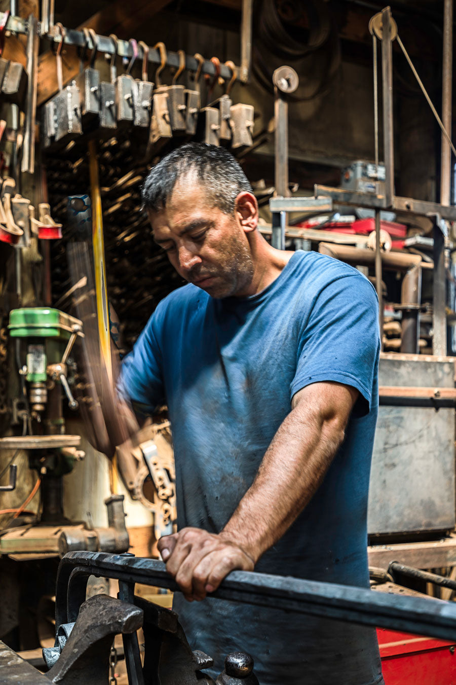Pedro Cabos working in a blacksmith shop.