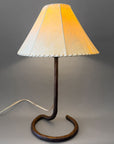 Wrought iron hand forged bedside lamp with a unique circle base and a sheepskin shade.