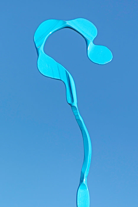 Abstract blue steel sculpture in the shape of a crook.
