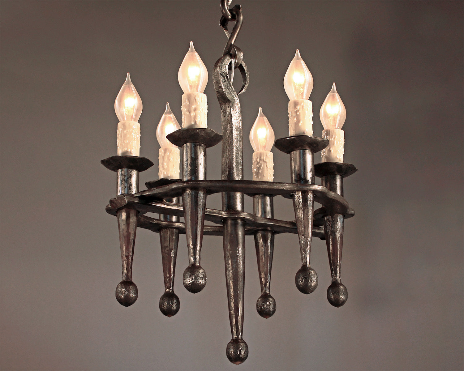 Old world style wrought iron chandelier. Small Rustic Fleur Chandelier by Christopher Thomson.