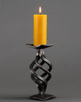 Single Swirl Iron Candle Holder with a beeswax candle.