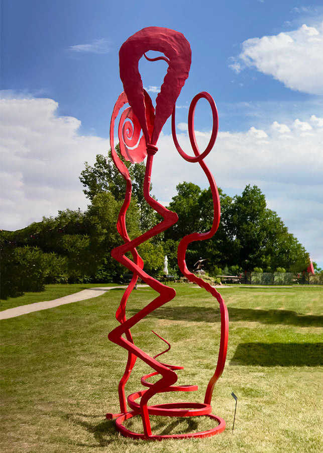 A monumental abstract red steel sculpture standing on a green lawn.
