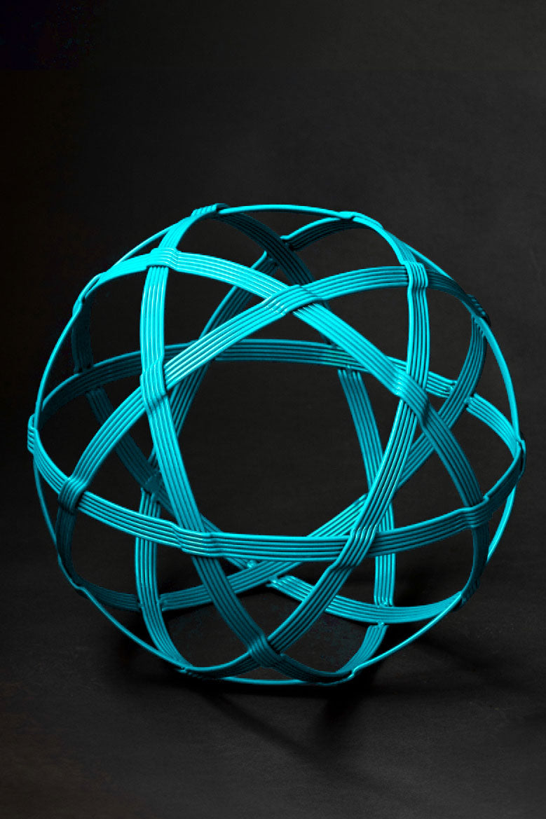 A turquoise colored Chinlone Garden Orb metal sculpture by Christopher Thomson Ironworks.