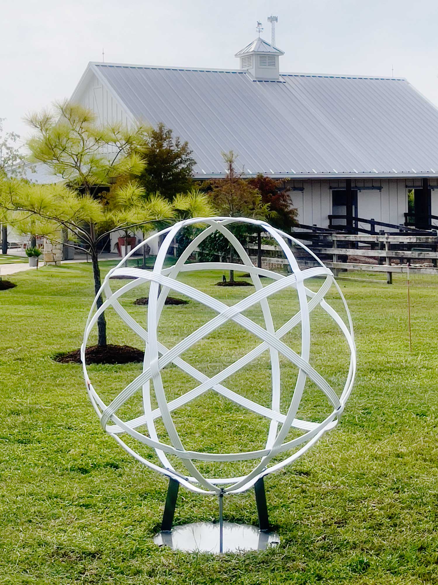 White metal garden sphere sculpture by New Mexico blacksmith, Christopher Thomson.