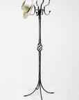 Hand forged wrought iron standing coat rack with multiple hooks.