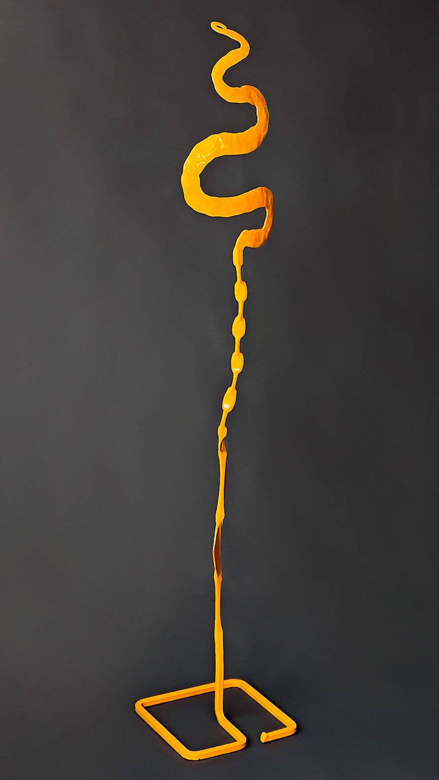 A minimal, free standing yellow steel sculpture by Christopher Thomson Ironworks.