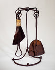 Wrought iron fireplace tool set with a natural rust finish. Standing fire tool set with four fire tools including a broom, fire poker, shovel and tongs.