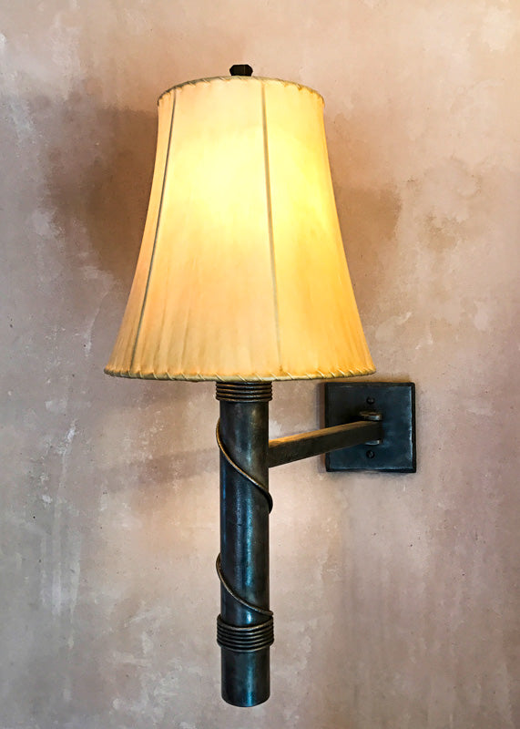 Hinged Torch Iron Wall Sconce shown with a Sheepskin Shade.