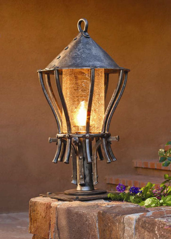 Hand forged outdoor Wrought Iron Post Lantern installed along a walkway for pathway lighting. Made by blacksmith, Christopher Thomson in Santa Fe, New Mexico.