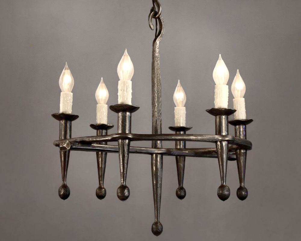 Rustic Fleur Wrought Iron Chandelier made from hand forged steel. Features six torches with candle lightbulbs.