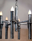 A classic hand forged medieval style wrought iron chandelier with five candelabra torches.