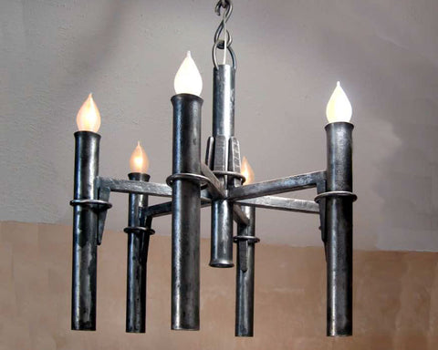 A classic hand forged medieval style wrought iron chandelier with five candelabra torches.