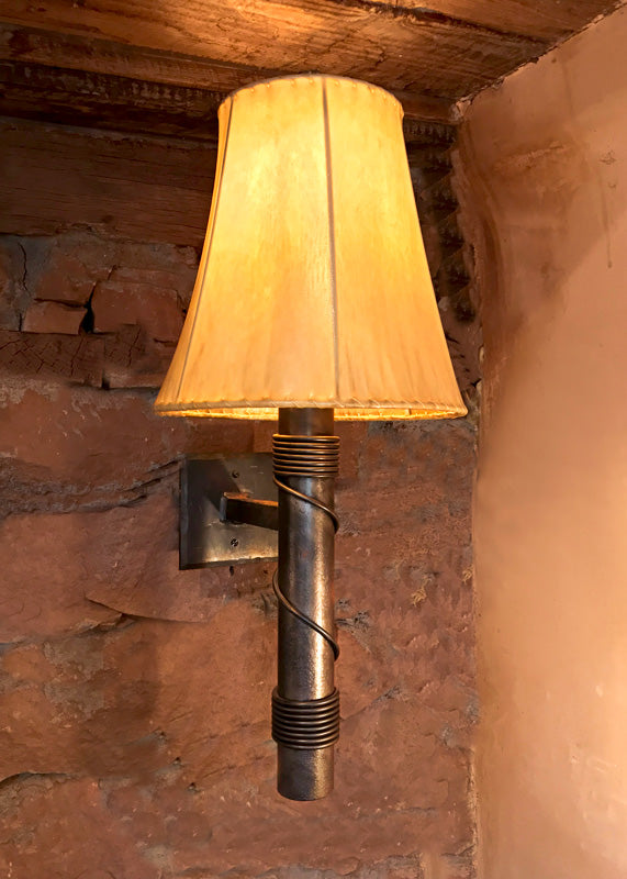 Forged Steel light fixture, Stationary Torch Wrought Iron Wall Sconce, shown with a Sheepskin Shade.