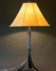 Twisted Valley Wrought Iron bedside lamp with a handmade sheepskin shade. Elegant wrought iron design Featuring a thin piece of twisted iron that wraps tightly around the base of the stem, loosening in the middle, and finishing tightly again at the top of the stem.