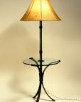 Wrought Iron Lamp Table shown with a raw hide sheepskin shade. The floor lamp extends out of the center of the table, serving as a table/lamp combo.