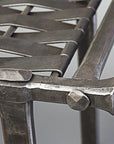 Close up of hand forged Woven Iron Bench corner.