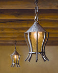 Large hand forged Contemporary Pendants hanging from the ceiling on s-hook chains.
