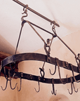 Kitchen Wrought Iron Pot Rack made by Santa Fe blacksmith, Christopher Thomson Ironworks. It is oval shaped with double sided hooks for pots and pans.