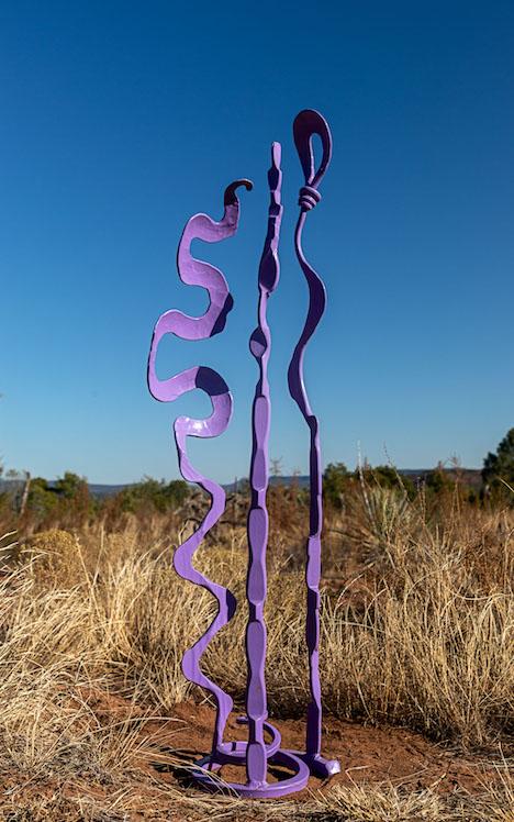 Small lavender abstract steel sculpture.