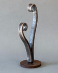 Side view of a small wrought iron heart sculpture.