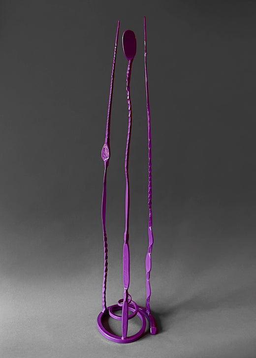 Purple forged steel garden sculpture  that is free standing with three long tendrils pointing up.