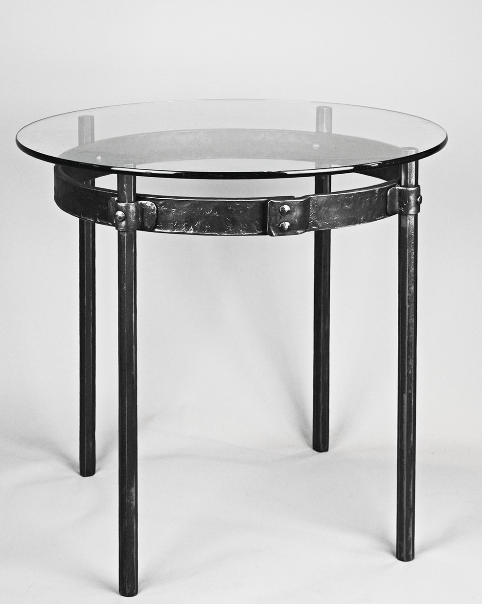 Hand forged wrought iron Ring End Table shown with a round glass top.