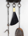 Wrought iron wall mounted fireplace tool set with a hand forged fire poker, broom and shovel.