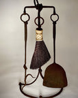 Wrought iron fireplace tool set with a fire poker, shovel and broom.