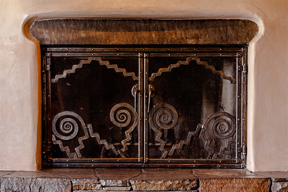 Custom hand forged wrought iron fire screen by Christopher Thomson on display at the Inn of the Anasazi hotel in Santa Fe, New Mexico.
