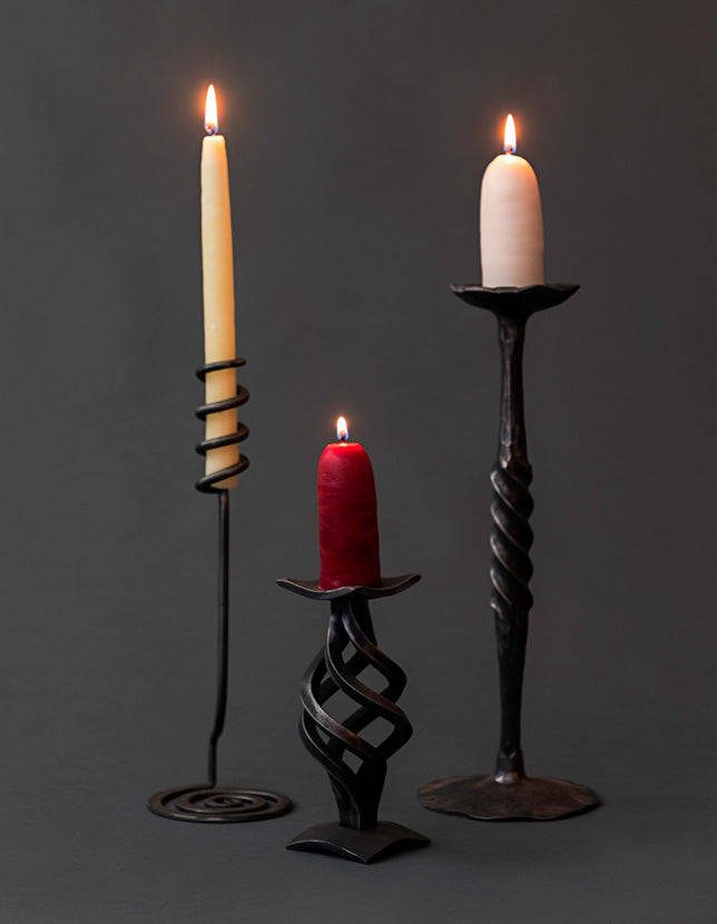 Wrought Iron Candle Holders made from forged steel. Each hand forged iron candle holder is a different style.