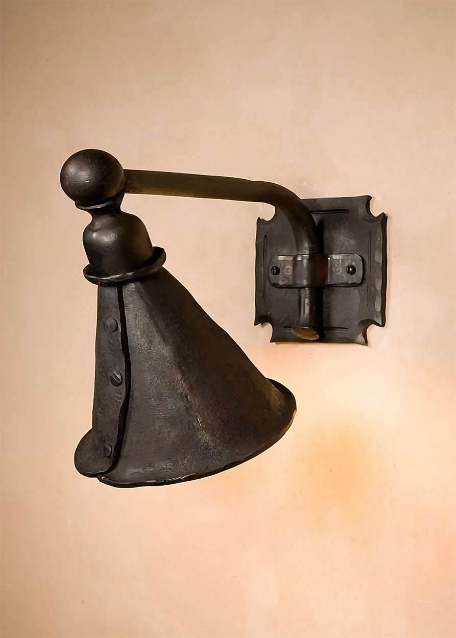 Wrought Iron Library Wall Sconce with a down directing cone shaped hood. This iron light fixture is affixed to the wall with a horizontal arm and a square bracket plate.