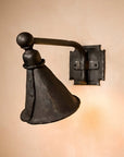 Wrought Iron Library Wall Sconce with a down directing cone shaped hood. This iron light fixture is affixed to the wall with a horizontal arm and a square bracket plate.