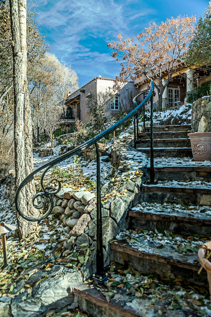 Custom wrought iron stair railing leading up to a Santa Fe home.