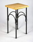 A hand forged steel pedestal table with a flagstone top. Wrought iron design.